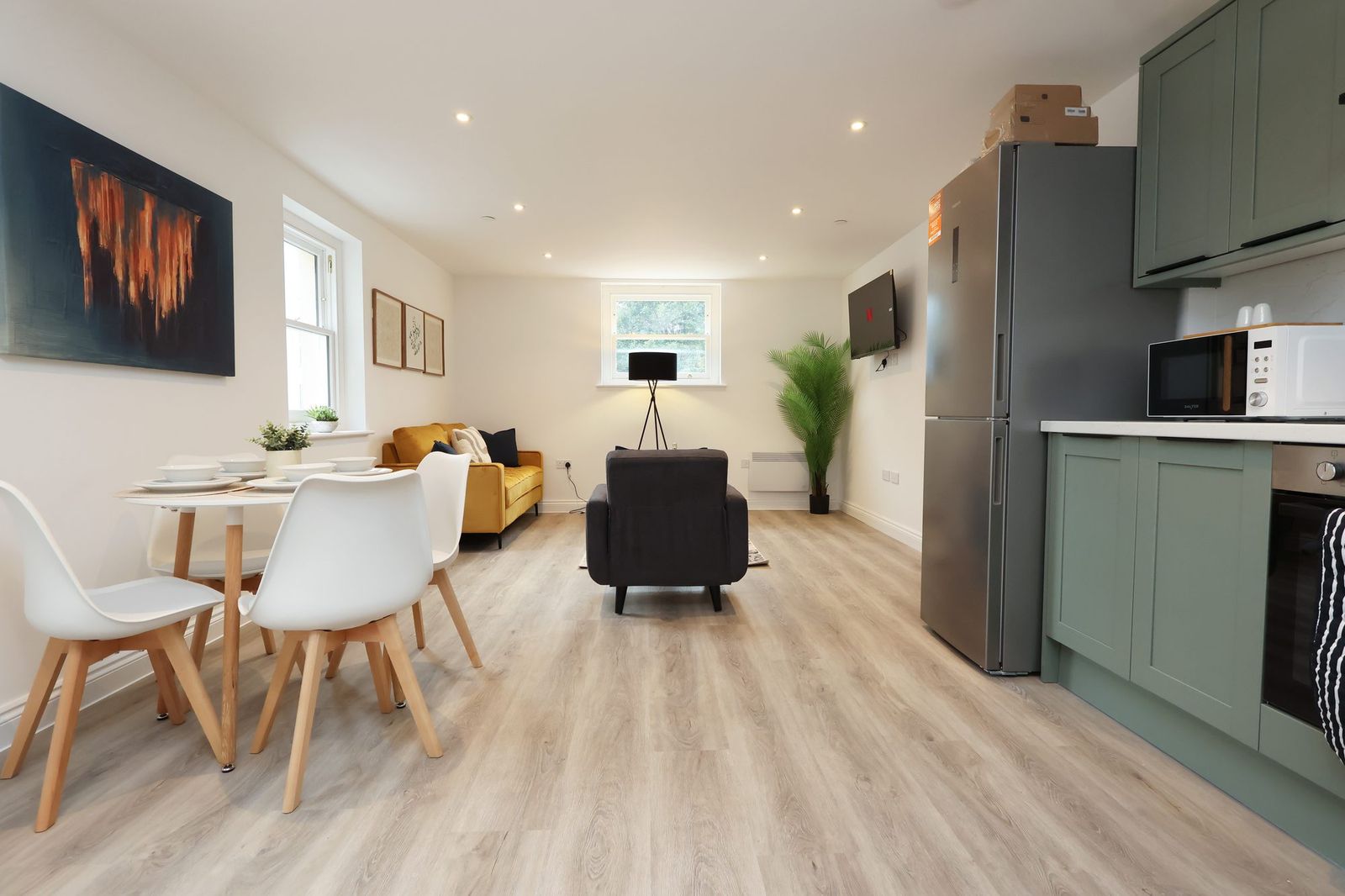 The living room, dining table and kitchen in one space